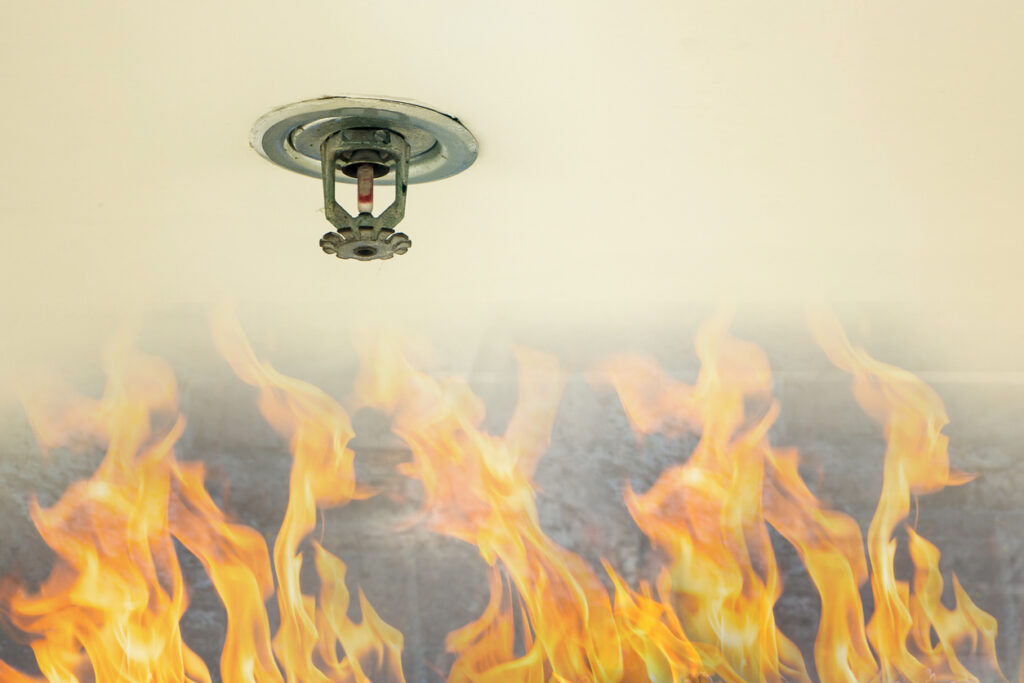 Fire protection. Fire sprinkler head on white ceiling in a building, sensor action when the smoke detected.