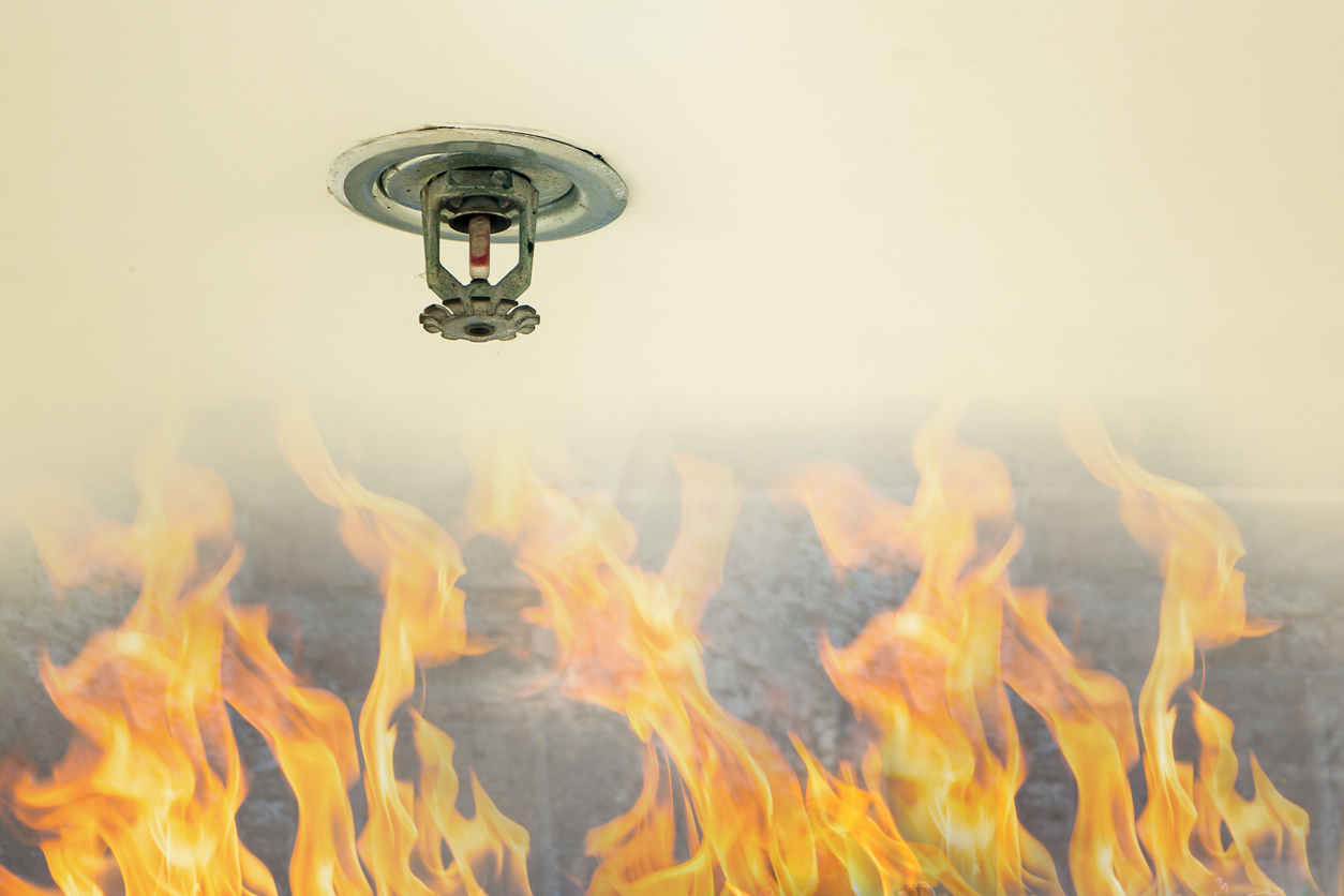 Fire protection. Fire sprinkler head on white ceiling in a building, sensor action when the smoke detected.