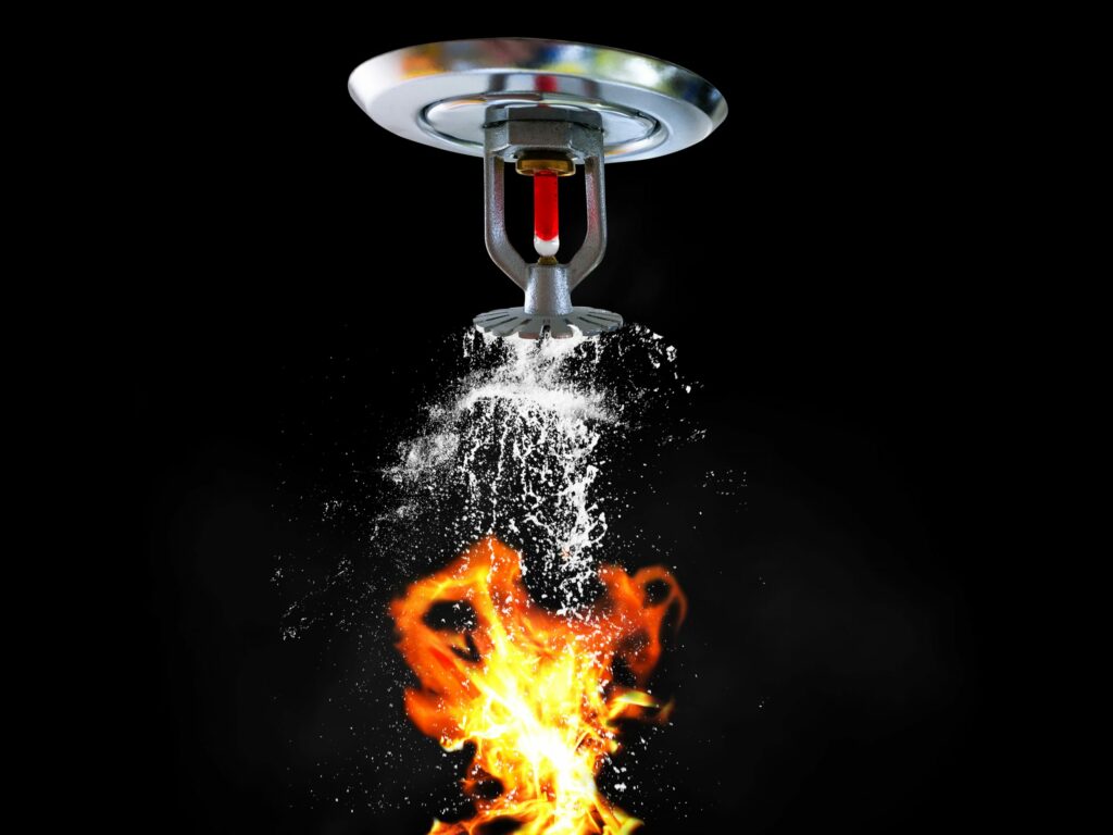 water sprinkler over fire black background